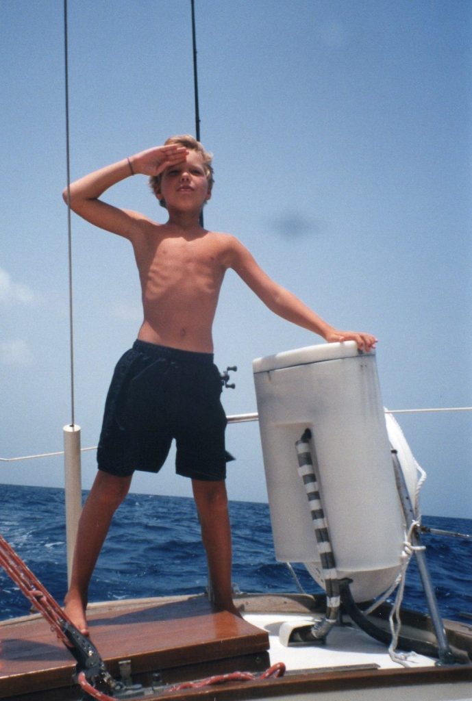 Tyler on stern of our family sailboat Bonair