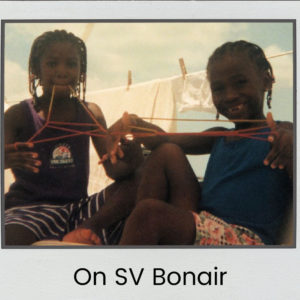 two of our daughters playing string games on our boat 