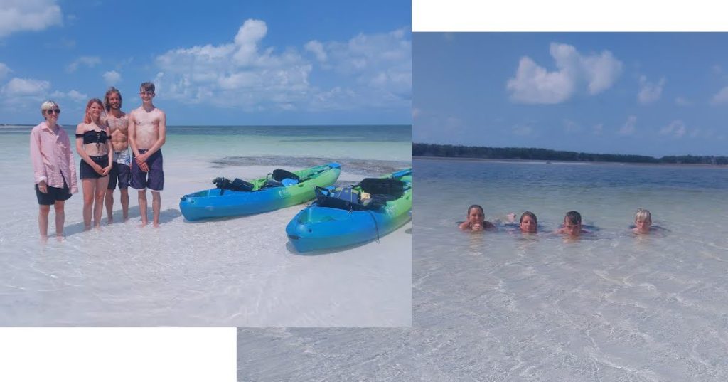 kayaks at sand bar and family lounging in the shallow, clear water at sand bar