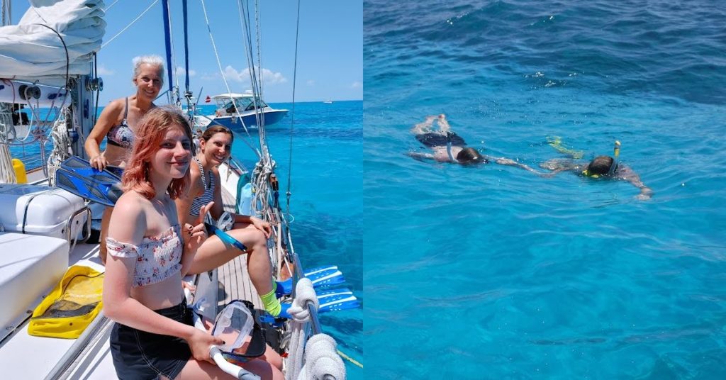 granddaughter, mom, grandma on side of sailboat getting snorkel gear on and two of the family swimming in the water snorkeling
