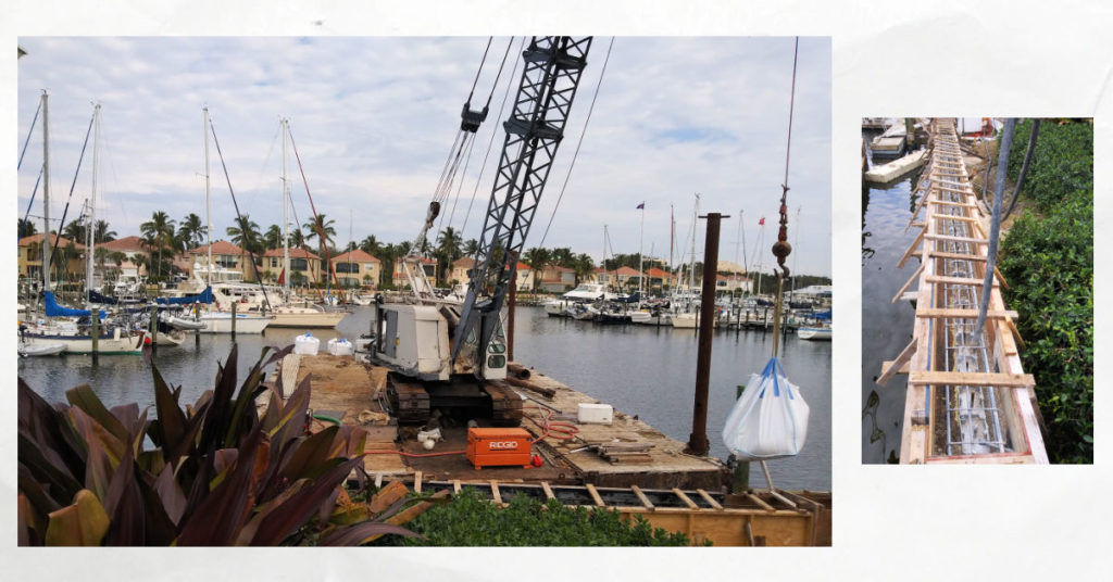seawall construction with crane on floating barge, cement being poured into seawall form
