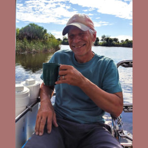 captain drinking tea in cockpit of sailboat after the storm  