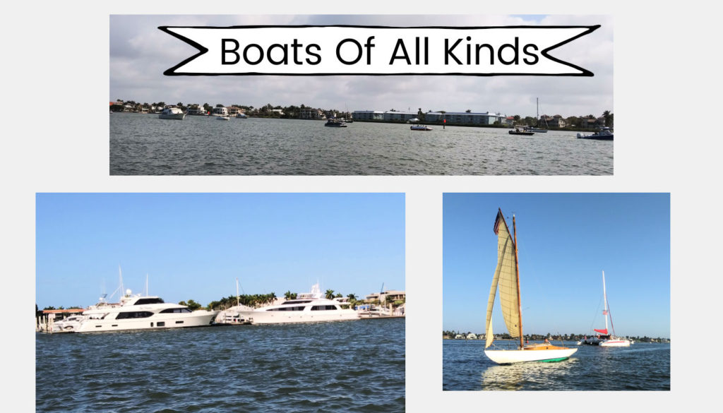classic sailboat on the water, catamaran, large yachts at dock, small boats in the channel 
