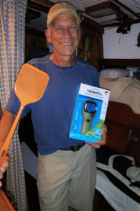 Tony holding a few of our supplies to deal with bugs: fly swatter and thermacell.  