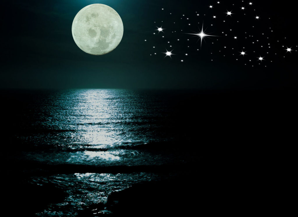 moon reflecting light over the water, stars in the sky
