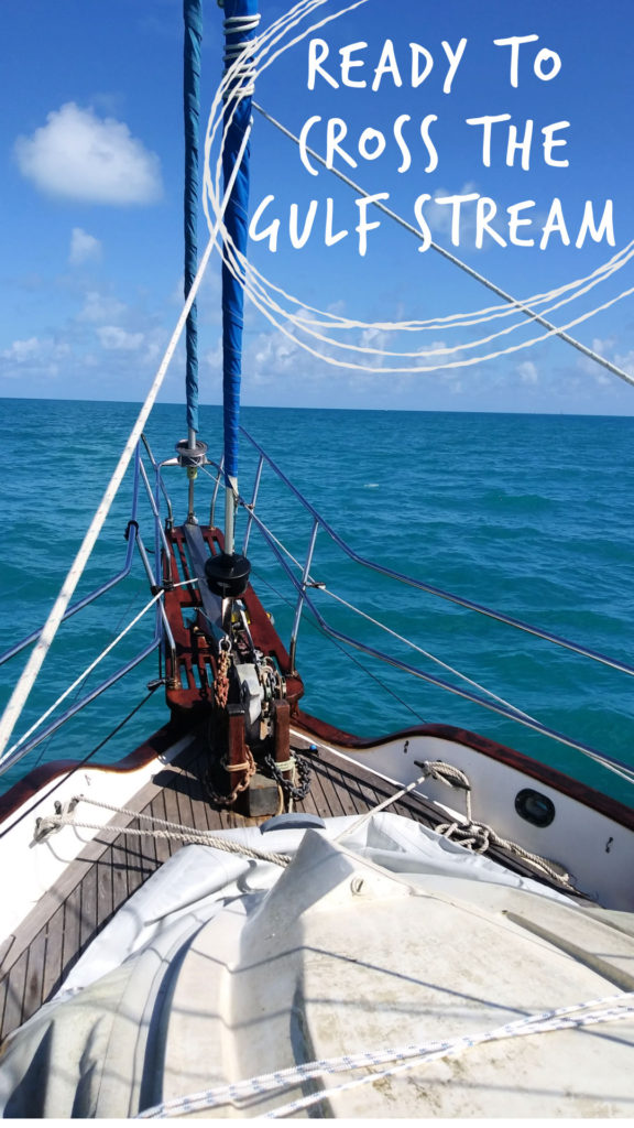 dinghy up on deck on bow of sailboat