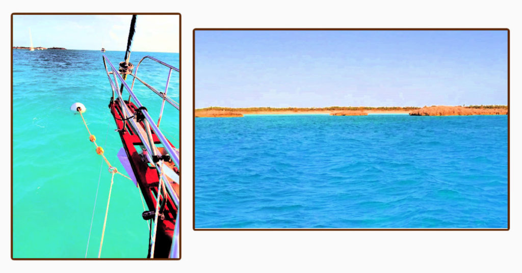 sailboat bow on a mooring ball and view from the boat towards Shroud Cay of rocky islets and mangroves