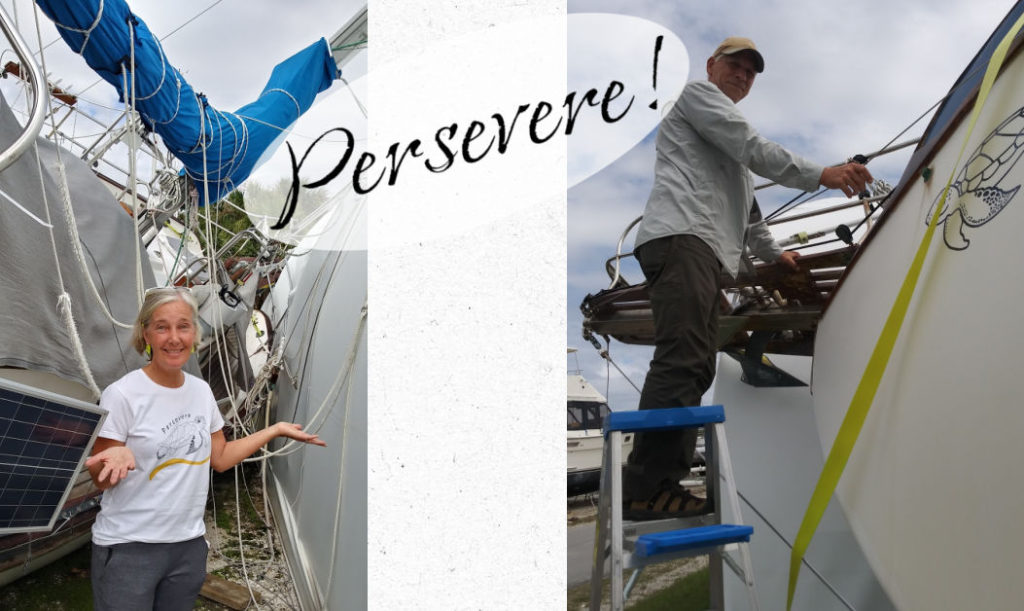 Julie with persevere Tshirt on next to sailboat on her side and tony on ladder checking out damage to bowsprit 