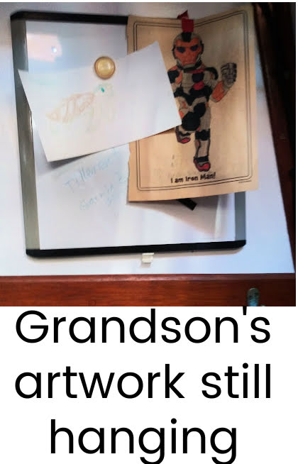grandson's artwork hanging on white board