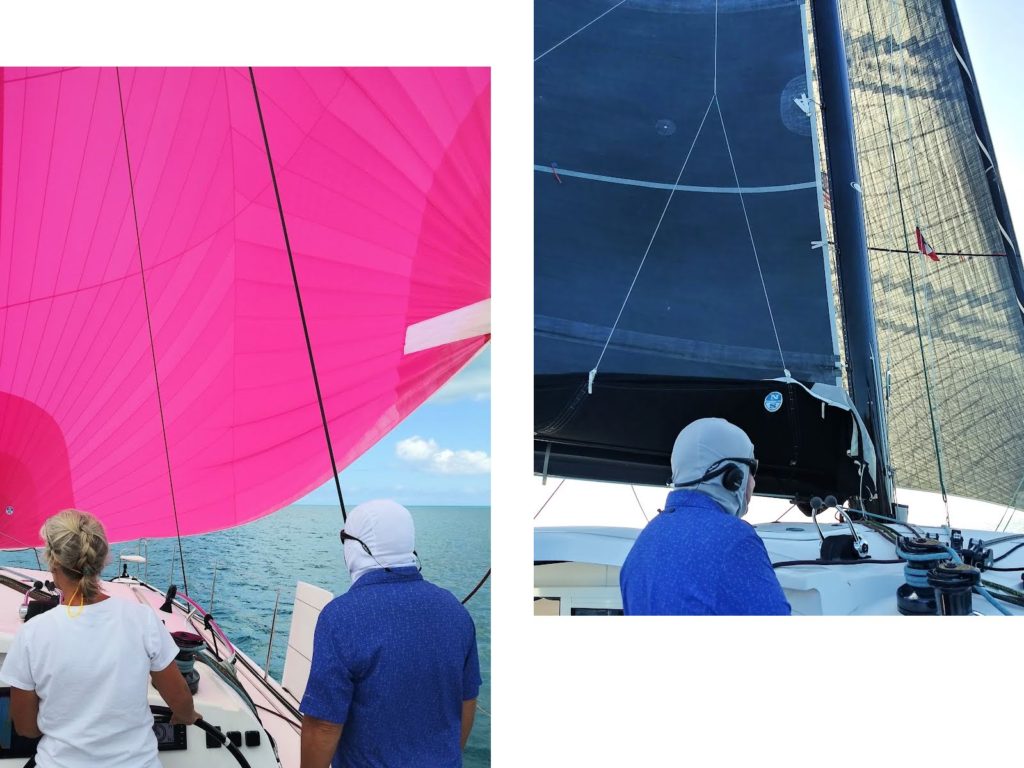 different sails up, a main and jib and an assymetrical, while sailing on catamaran 