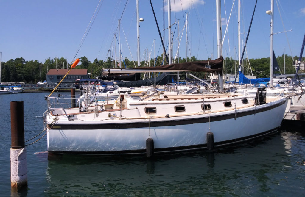 Com Pac 33 at dock in a marina 
