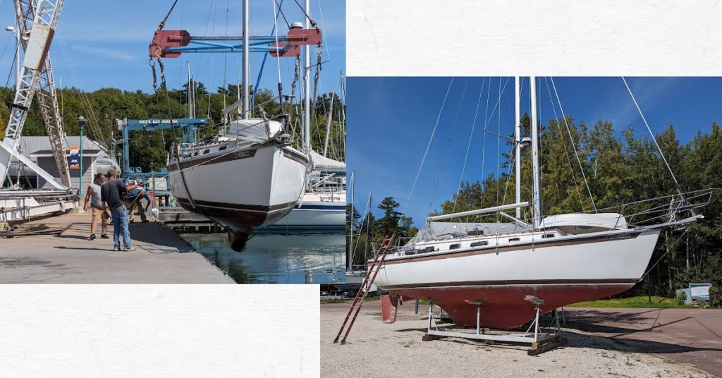 sailboat getting hauled out of the water and on a cradle in the parking lot