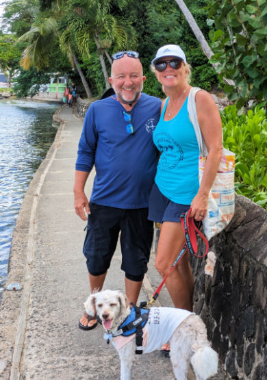 Dog on a walk near the water with his owners Doug and Amy 