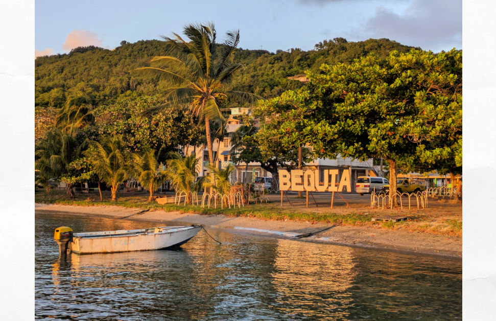 bequia water front sign and fishing boat 