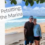 couple standing on the beach with water in the background