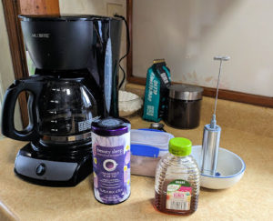 coffee pot, chamomile tea, honey on kitchen countertop 