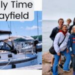 sailboat at dock photo of 8 family members with lake superior in background