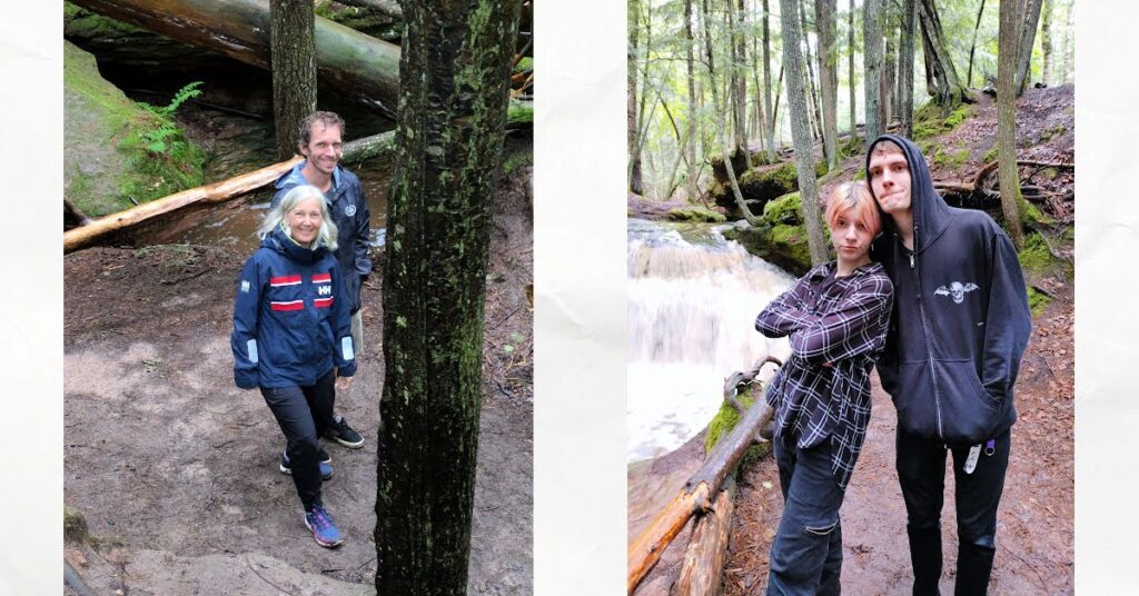 people on rocks near waterfall; siblings together and mother and adult son together 