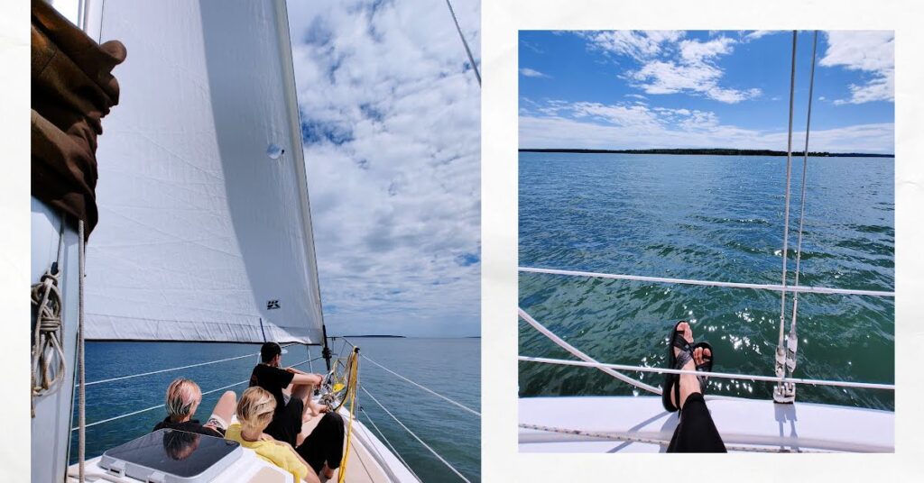 bow of sailboat with sail up and 3 young adults relaxing, pic of woman's sandals on side deck of sailboat with water and island in the distance 