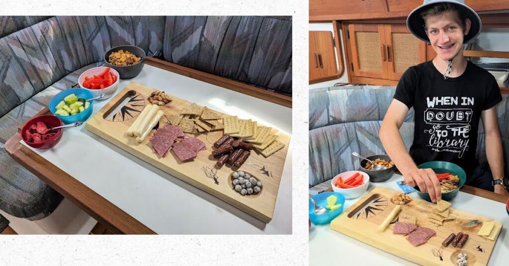 charcuterie board with teen boy helping to arrange food on it 