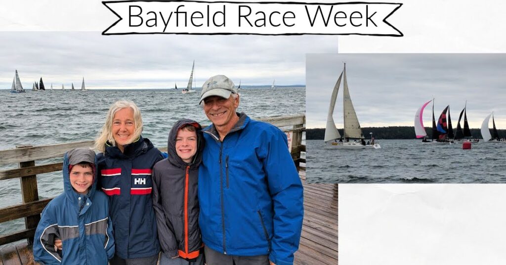 grandparents and grandchildren on dock with racing sailboats in the background