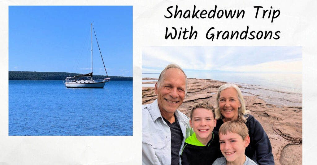 sailboat at anchor, grandparents and grandsons on big rocks overlooking water