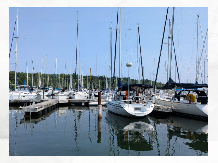 docks at marina with an empty slip and dock neighbors waving goodbye