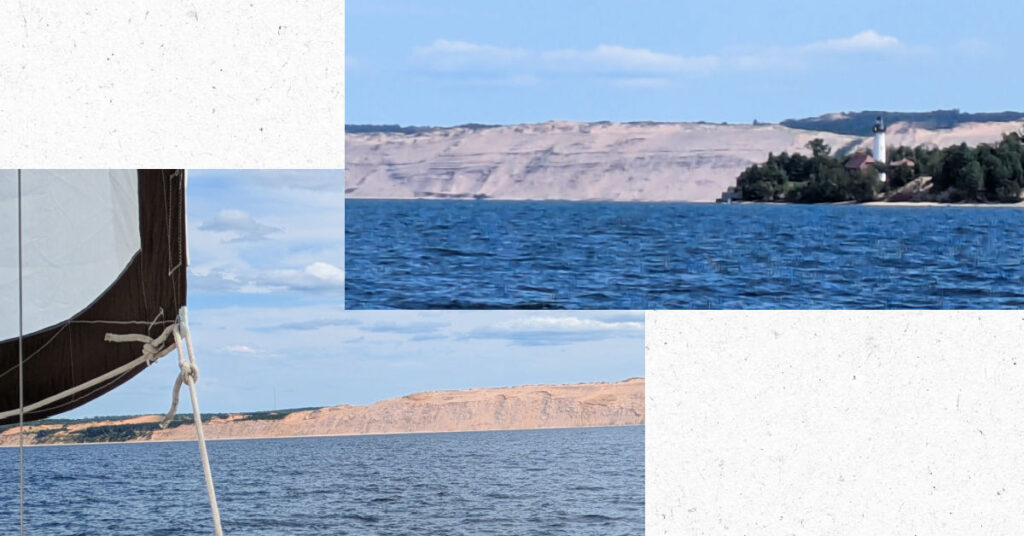 grand sable sand dunes on lake superior with lighthouse, sanddunes from sailboat with sail out 