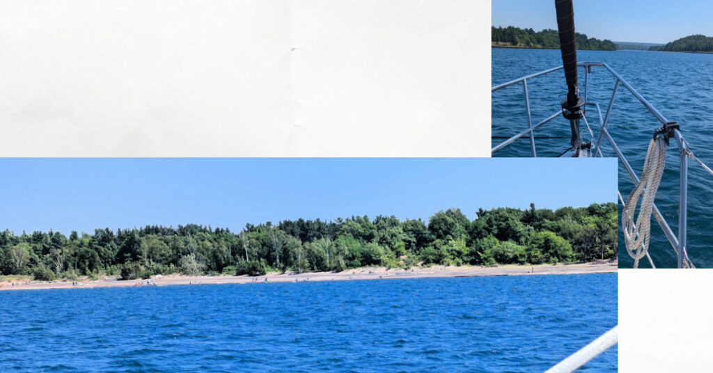 Keweenaw Waterway Upper entrance from sailboat, beach area, narrowing of canal with greenary on sides 