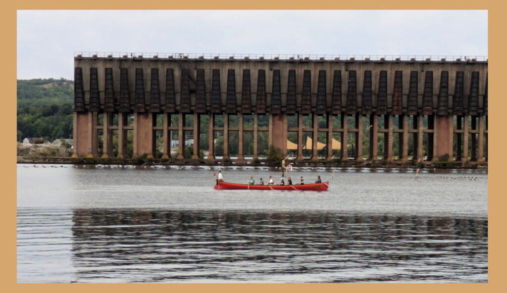 rowers in front of Marquette old iron ore 