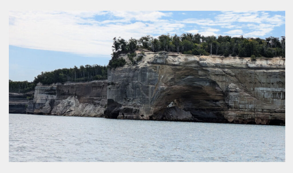 pictured rocks on lake superior with an arch in the rock 