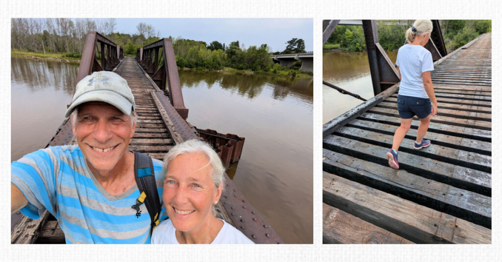 couple selfie pic on old railroad bride, woman walking carefully on the railroad bridge over river 