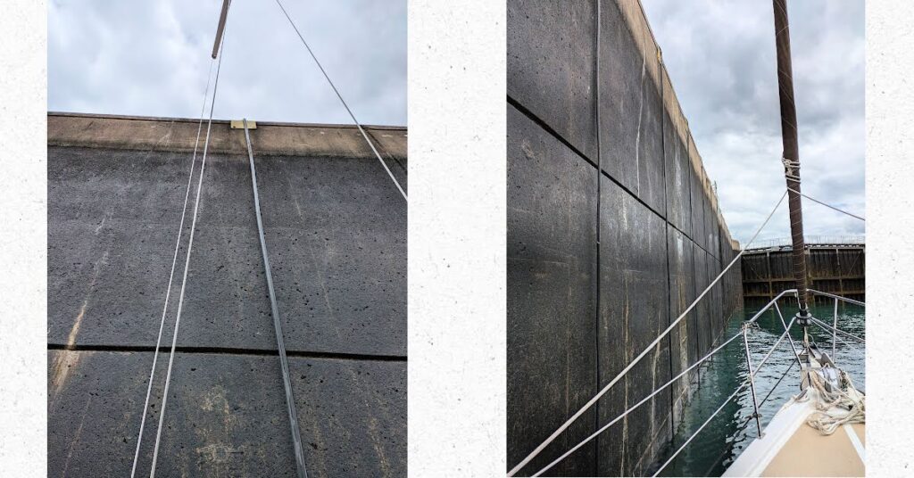 walls of the lock from the vantage point of sailboat as water dropped, closed gates in front of boat 