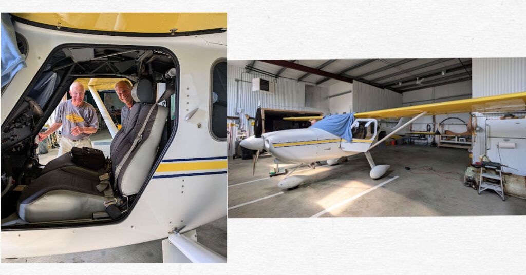 men looking into cockpit of small plane, small plane in a hanger