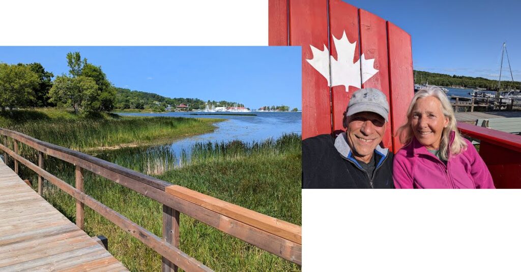 couple in one of Canada's red chairs, nature board walk overlooking anchorage