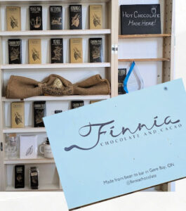 chocolate shop shelves with choclate bars and business sign "finnia"