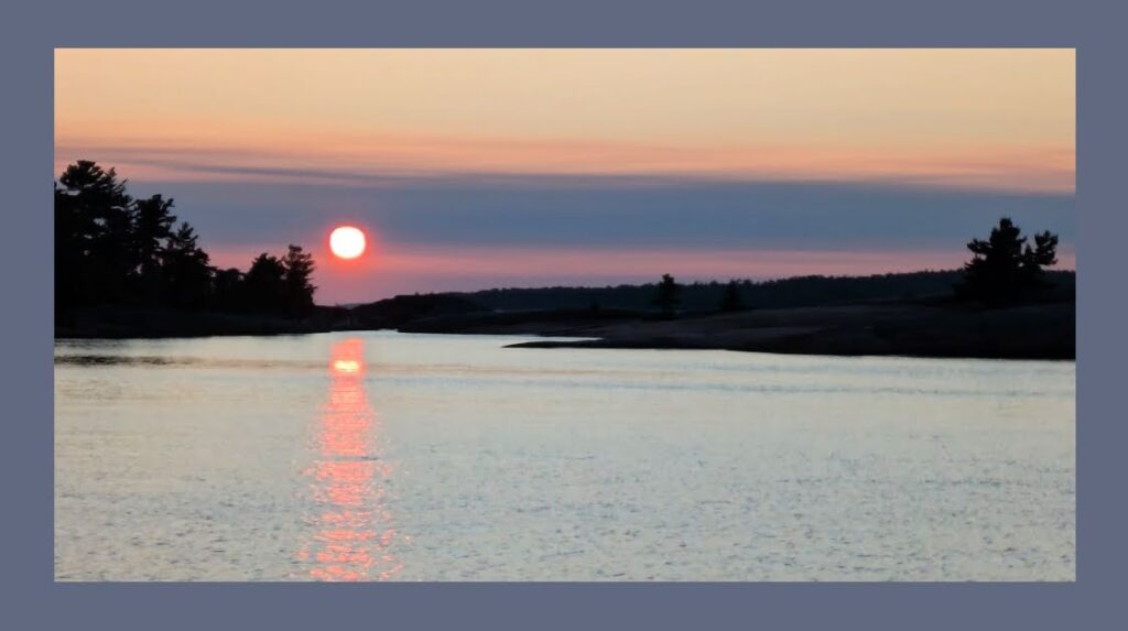 sunset over water and trees