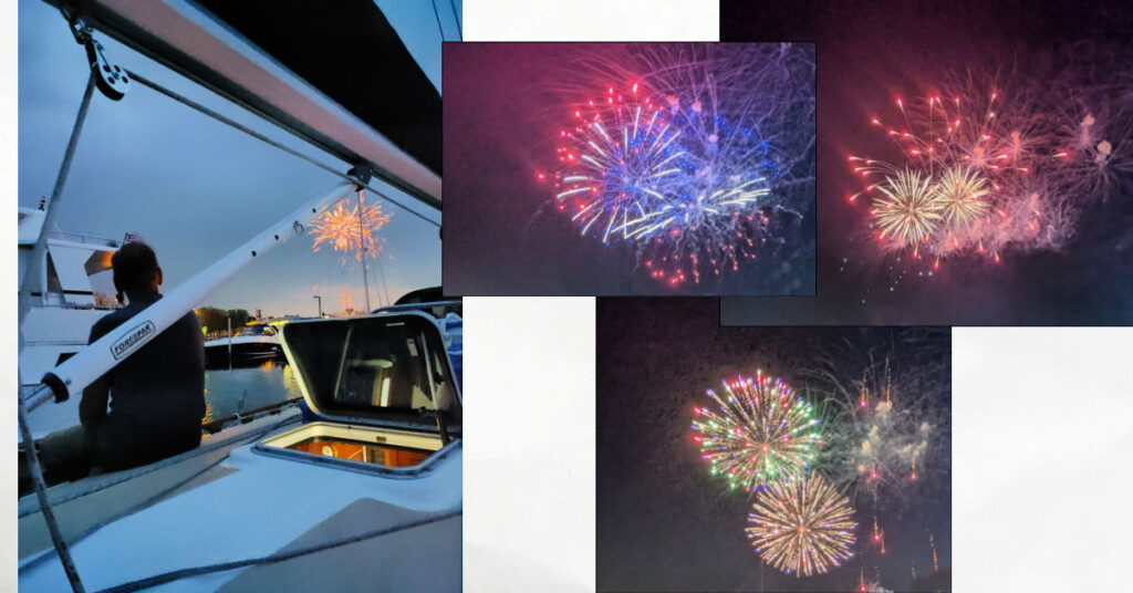 fireworks in the dark sky, man on deck of sailboat at dock watching fireworks in the sky