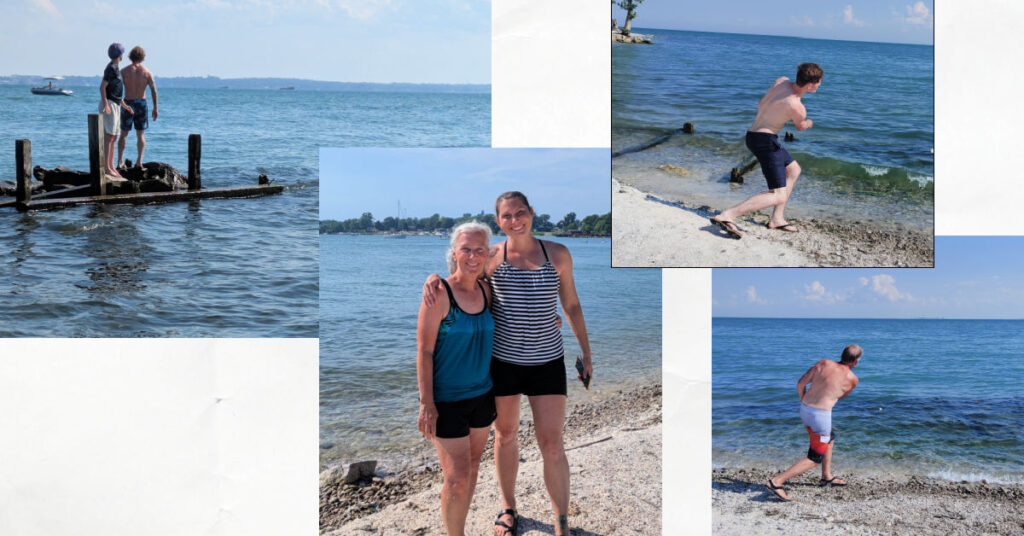 at a rocky beach; men skipping rocks, father and child out on some rocks in the water, two women at waters edge 