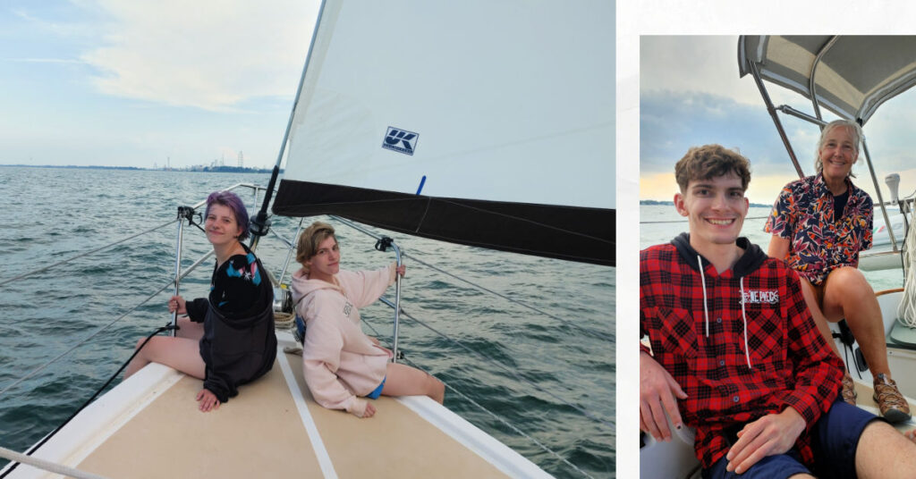 two young adults on bow of sailing boat, grandma and grandson in cockpit of sailing boat