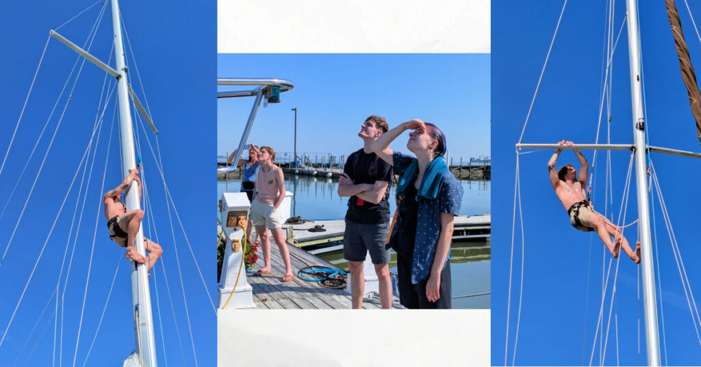 man going up the mast of a sailboat, family on dock watching