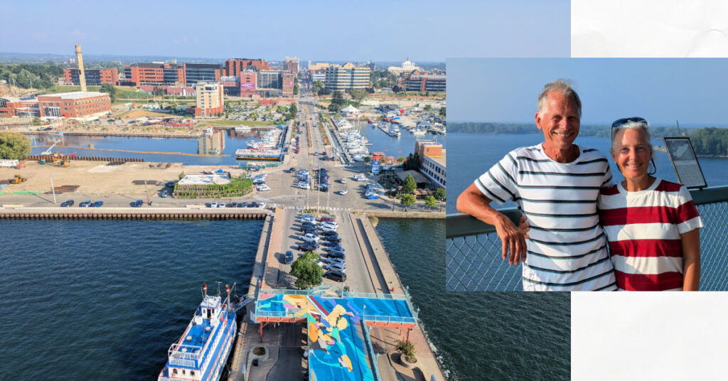 view of Erie, PA from bicentennial tower, grandparents with overlook of the bay behind them 