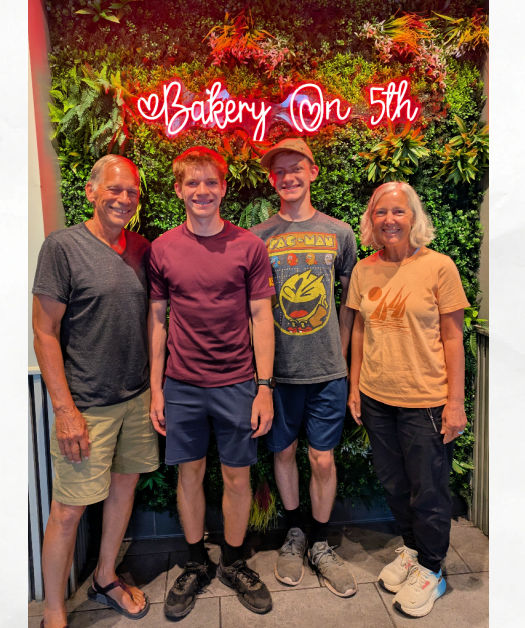 grandparents and teen grandsons at bakery on 5th greenery wall background 