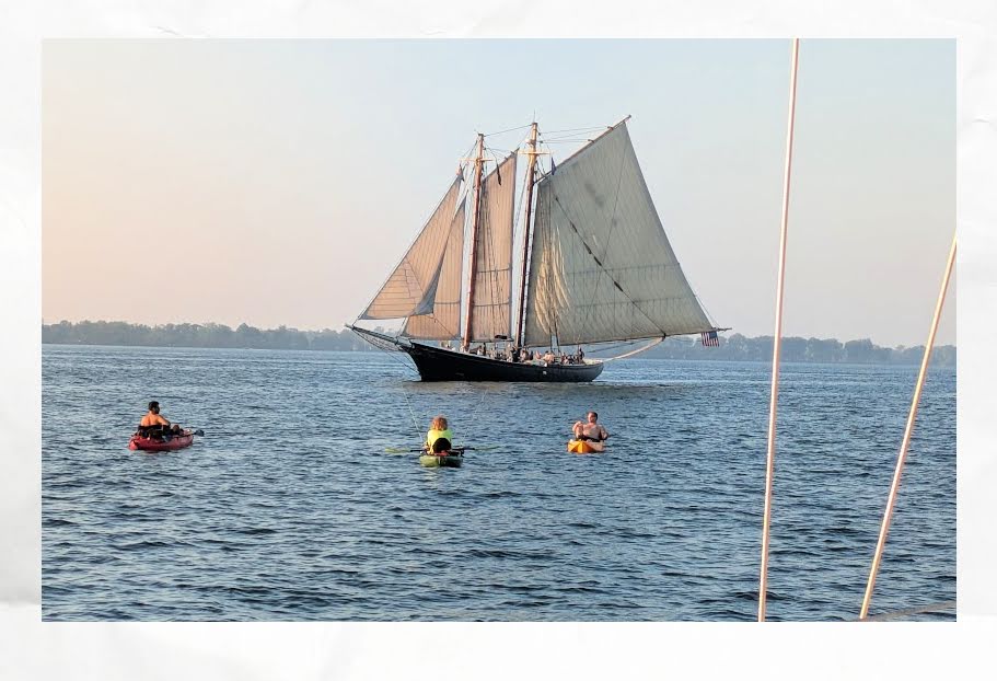 schooner sailing with kayaks in forground 