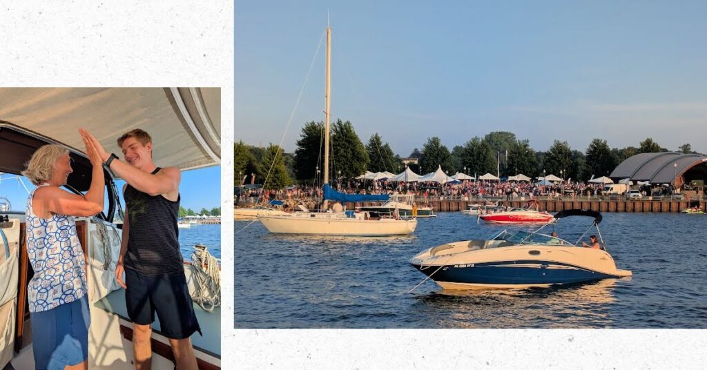 boats at anchor with concert on shoare, grandma and grandson high fiving in cockpit 