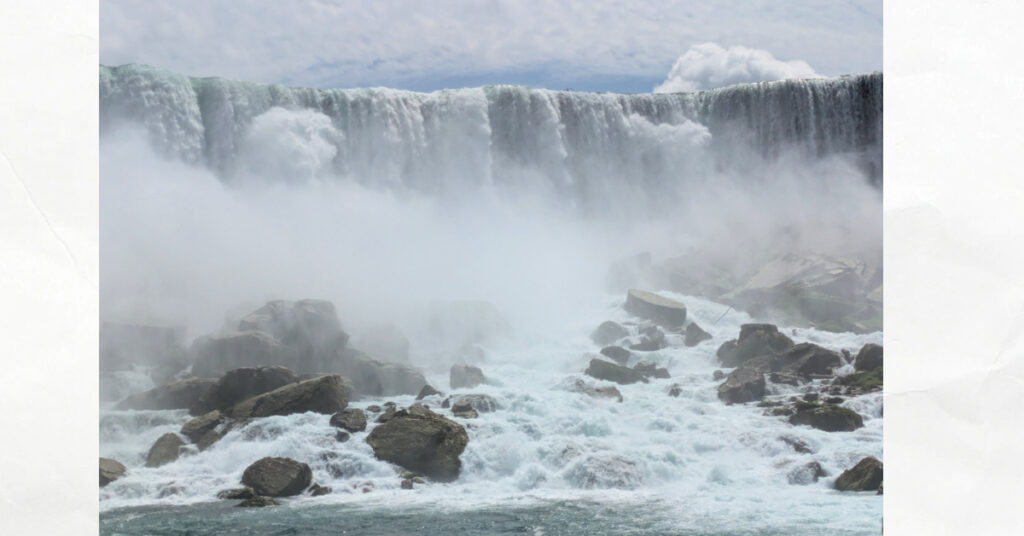 niagara falls water falls and rocks below 