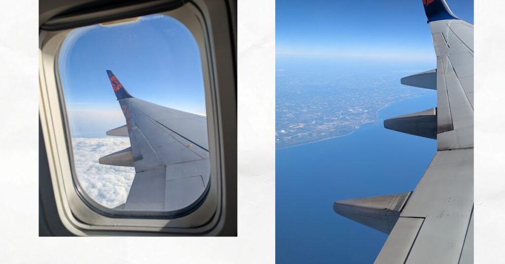 airplane wing seen from window, clouds and town and water below 

