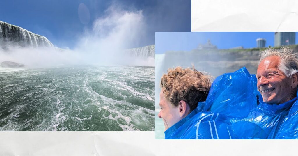 grandpa and grandson on maid of mist boat ride getting wet from falls, turbulant water below the falls and mist rising 
