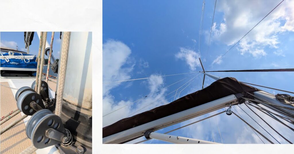 view of mast and boom looking up at sky, close up of lines at base of mast 
