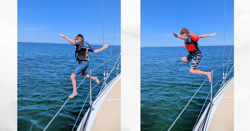 boys jumping off side of sailboat into Lake Erie 

